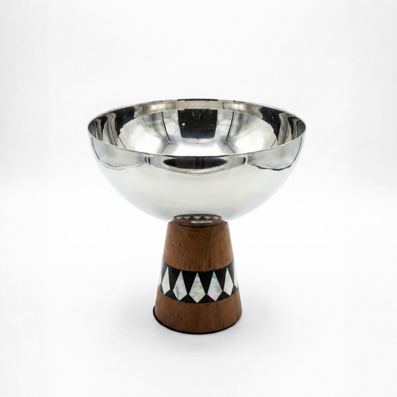 Coupe à fruits sur pied en acier poli miroir avec socle en marqueterie géométrique noire et blanche.