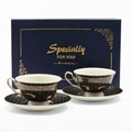 Set de tasses et soucoupes noir et or devant coffret cadeau Majorelle